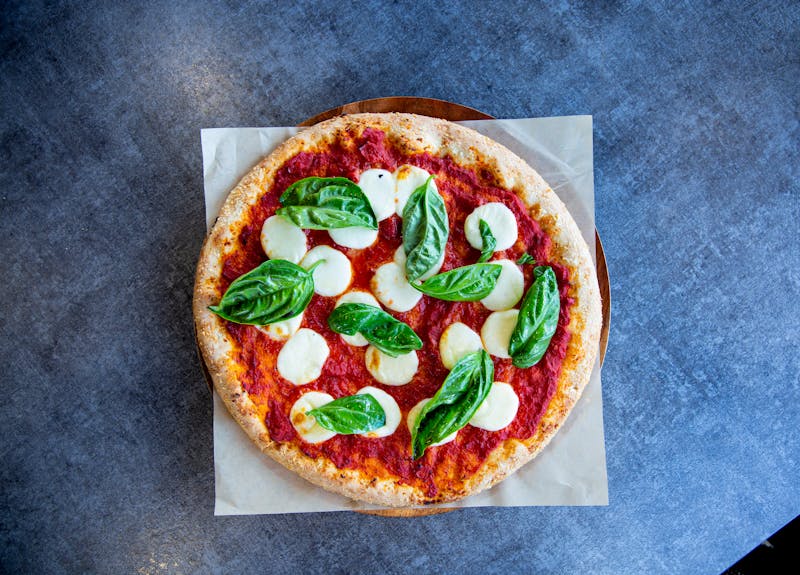 Classic Margherita pizza with fresh basil and tomato sauce